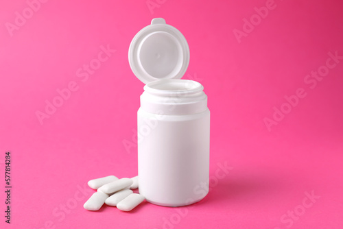 Jar with chewing gums on pink background © New Africa