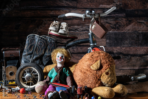 Obraz na plátne old toys in attic with dark wood background including tricycle stuffed lion and