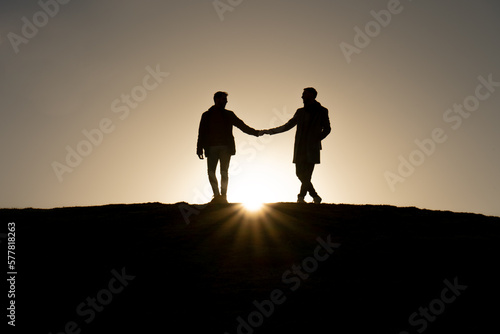 Silhouette of gay couple in love.
