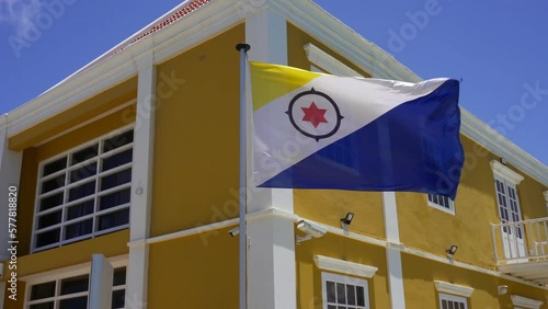 Kralendijk, Bonaire, Caribbean Netherlands: Douanekantoor - Customs Office and flag of Bonaire. Black compass, red six-pointed star, dark blue and yellow triangles. photo