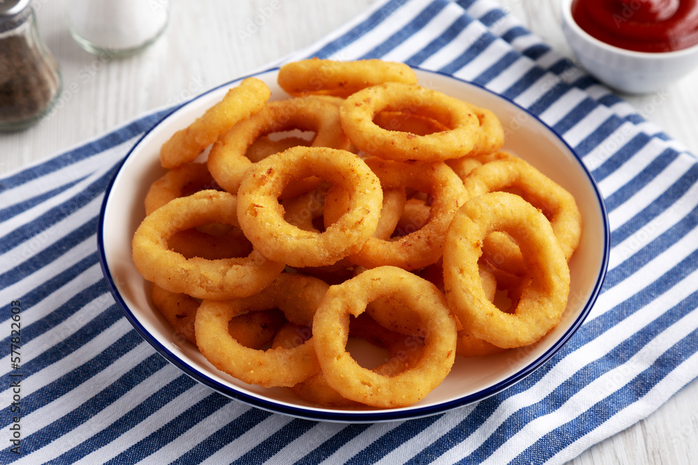 Homemade Breaded Onion Rings with Ketchup on a Plate, side view. Homemade Breaded Onion Rings with Ketchup on a Plate, side view.