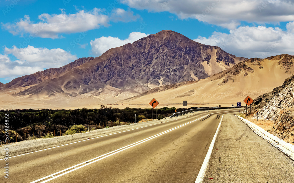 Empty coastal asphalt highway road in barren desert landscape - Panamericana, North Chile, Atacama Region