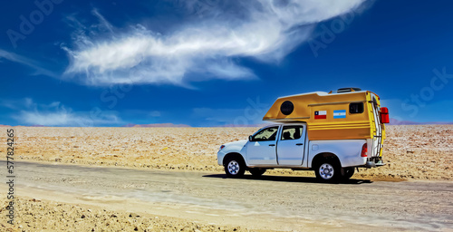 Wallpaper Mural Lonely camper truck van on dirt track road in white salt flat desert, blue sky - Salar de Atacama, Chile Torontodigital.ca