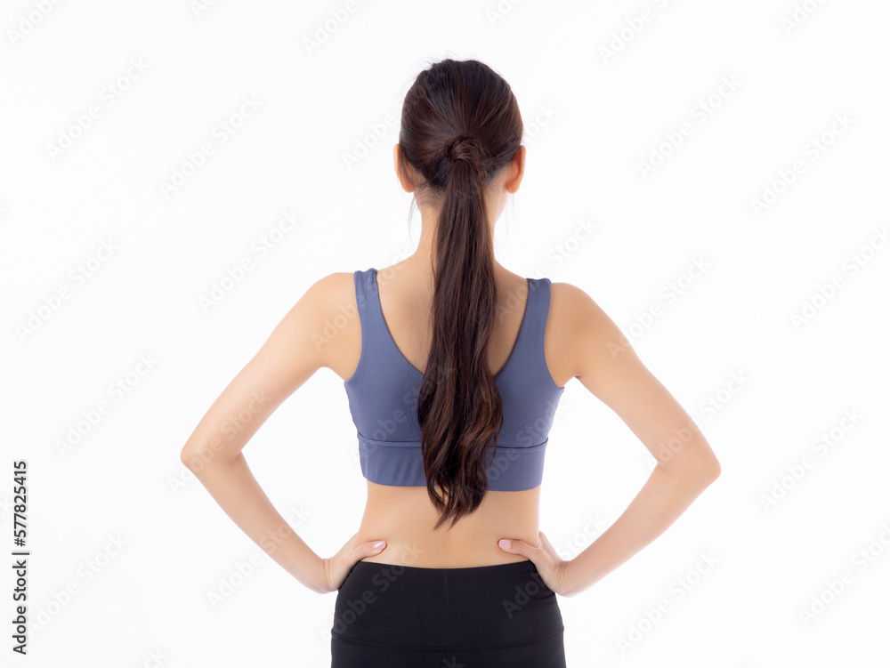 Portrait of beautiful young asian woman in sportwear smile and showing waist and abs isolated on white background, sport and exercise for health, female slimming with wellness, rear view. Portrait of beautiful young asian woman in sportwear smile and showing waist and abs isolated on white background, sport and exercise for health, female slimming with wellness, rear view.