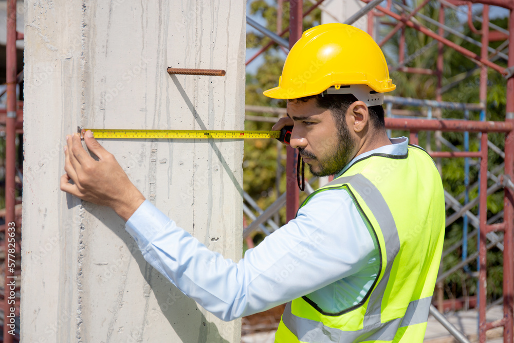 Engineer young man using tape measure for check and examining length of structure with professional at construction site, architect inspection and improvement infrastructure, industry concept. Engineer young man using tape measure for check and examining length of structure with professional at construction site, architect inspection and improvement infrastructure, industry concept.