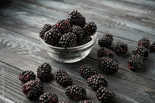 Ripe blackberries in bowls on the table