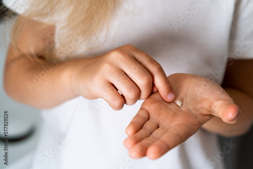 baby tooth on a child's palm close-up