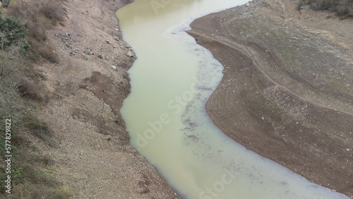 Drought in Türkiye. Drought crisis in Turkey. Aerial view of dam with low water level. Yuvacik dam or Kirazdere dam in Kocaeli Turkey. Drone view. Selective focus included. Noisy photo. photo