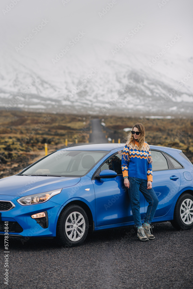 Naklejka premium a girl on the background of a car on a desert road
