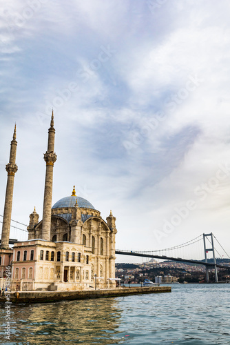 Ortakoy Mosque and the Bosporus in Istanbul, Turkey. The Bosphorus Bridge, aka the 15 July Martyrs Bridge, is a famous landmark in Istanbul, Turkey
