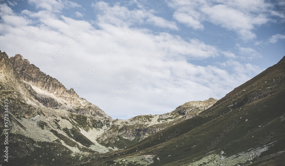 Mountain rocky pass and slopes with stone talus and vegetation, mountain landscape panorama Mountain rocky pass and slopes with stone talus and vegetation, mountain landscape panorama