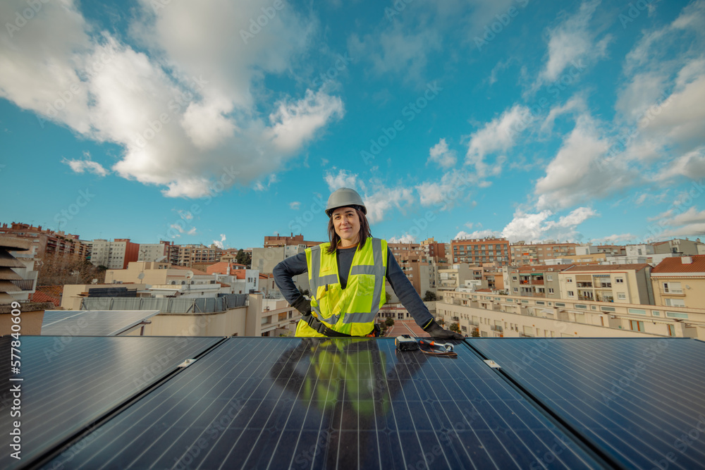 Confident Female electrician engineer in yellow best by urban Solar Panels Confident Female electrician engineer in yellow best by urban Solar Panels