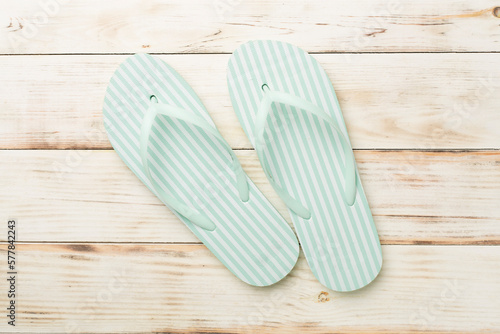 Striped flip flops on wooden background, top view