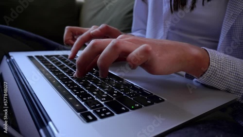 Female hands of business woman. User worker using typing on laptop notebook keyboard. Sit at home sofa working online with pc. Technology concept. Close up side view. Video 4K.