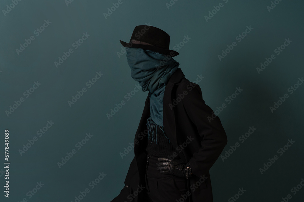 Invisible man, a character in a hat and coat, a scarf wrapped around his face, incognito concept