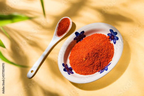 Canvas-taulu Tasty Spice: Paprika Powder in Ceramic Plate with Yellow Background and Natural