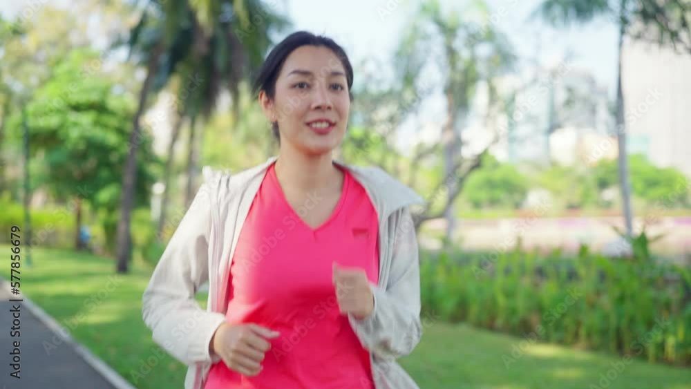 Attractive Asian woman in sportswear jogging exercise at public park in summer morning. Healthy girl athlete enjoy outdoor activity lifestyle sport training fitness running workout in the city. Attractive Asian woman in sportswear jogging exercise at public park in summer morning. Healthy girl athlete enjoy outdoor activity lifestyle sport training fitness running workout in the city.