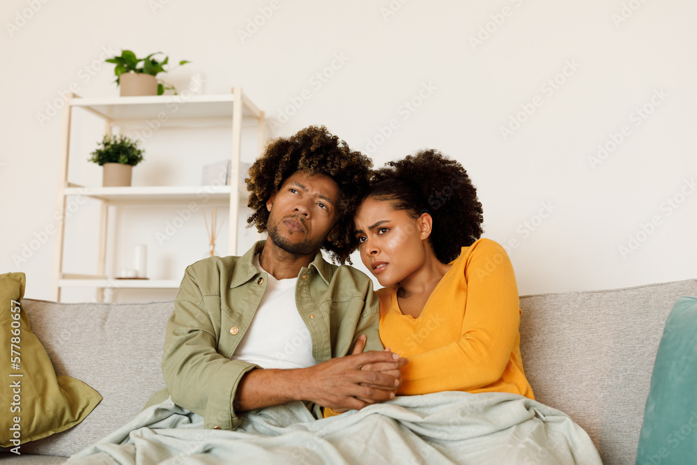 African Couple Watching Movie Or Negative News On TV Indoors African Couple Watching Movie Or Negative News On TV Indoors
