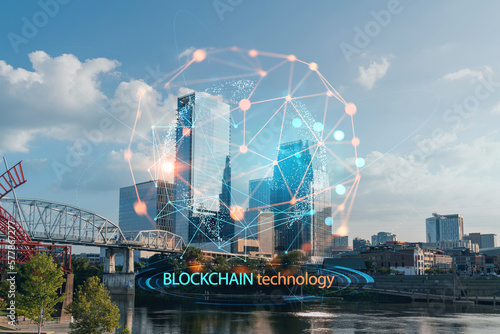 Panoramic skyline view of Broadway district of Nashville over Cumberland River at day time, Tennessee, USA. Decentralized economy. Blockchain, cryptocurrency and cryptography concept, hologram