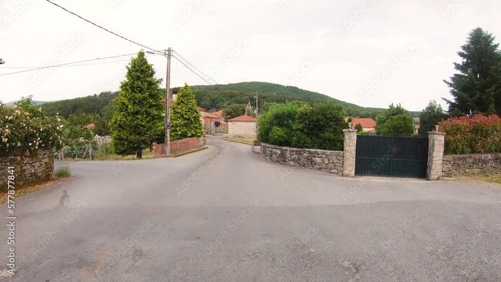 Camino de Invierno - a paved road passing through Penasillas village - Chantada, province of Lugo, Galicia, Spain - June 2022 Camino de Invierno - a paved road passing through Penasillas village - Chantada, province of Lugo, Galicia, Spain - June 2022