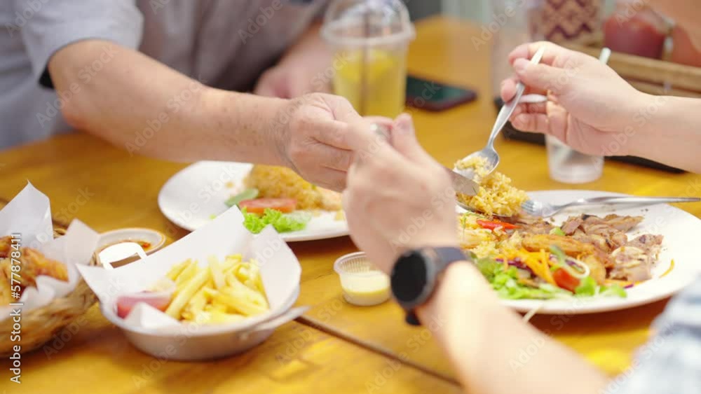 Happy Asian family couple and elderly father having lunch eating food together at cafe restaurant on summer holiday vacation. Family relationship, fathers day and older people health care concept. Happy Asian family couple and elderly father having lunch eating food together at cafe restaurant on summer holiday vacation. Family relationship, fathers day and older people health care concept.