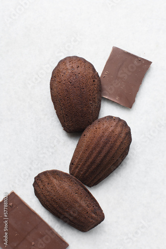 Top view of Chocolate madeleines on a marble tray, plain chocolate madeleine cake or cookies photo