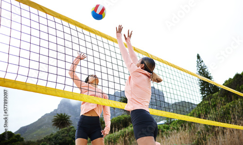 Volleyball, beach and spike with sports women playing a game outdoor for training or competition. Team, sport and ball with female friends on the sand by the coast to play a competitive match