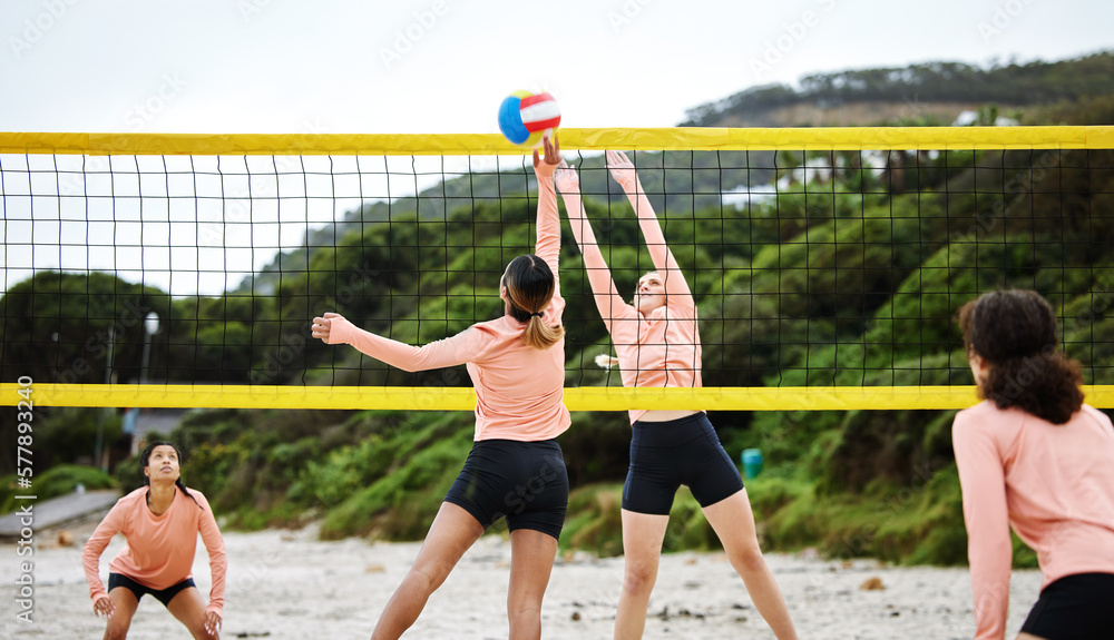 Volleyball, beach and competition with sports women playing a game outdoor for training in summer. Team, sport and ball with female friends on the sand by the coast to play a competitive match