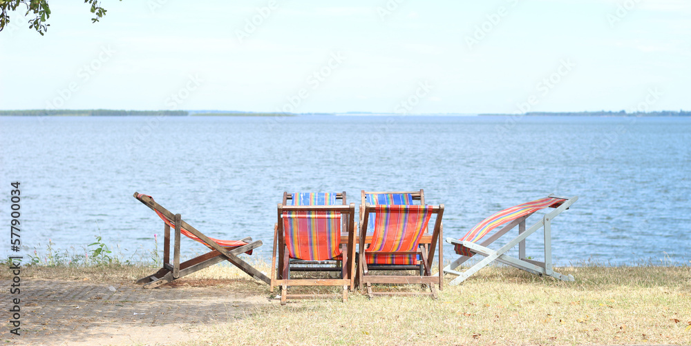 chairs and a lake in the background