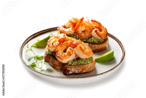 Toast or sandwich with Grilled fresh Spicy Prawns Shrimps with mashed avocado and lime slices. isolated on white background 