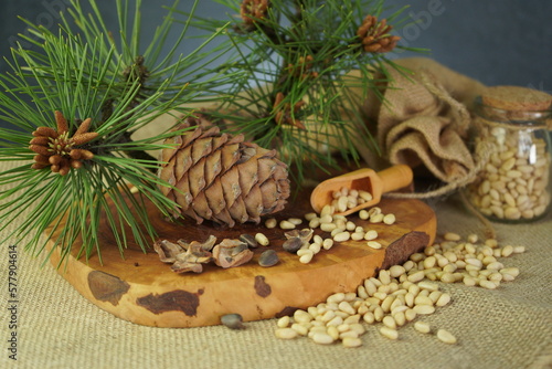 Cedar and spruce essential oil in glass bottle with pine nuts  cones composition