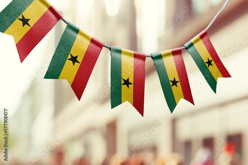A garland of Ghana national flags on an abstract blurred background