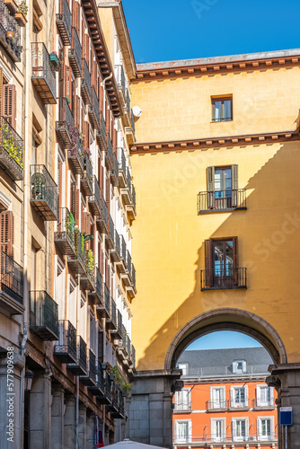 One of the entrance arches that give access to the main square of Madrid with its typical buildings of ancient times, Spain.