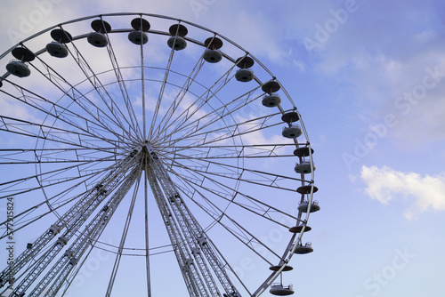 funfairs ferris wheel amusement park funfair attraction with blue cloud sky