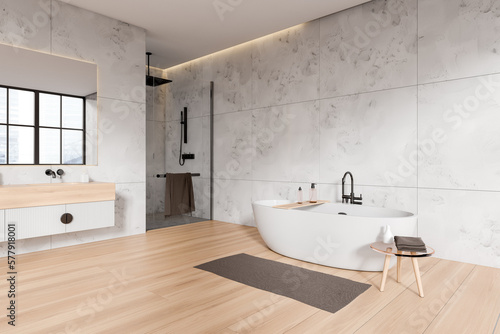 Stylish bathroom interior with sink  douche and bathtub with accessories