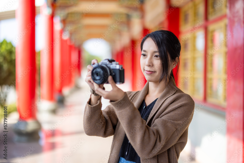 Travel woman use digital camera to take photo in Chinese temple