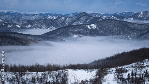 Fog in the valley, between the snow mountains in winter. © Branislav