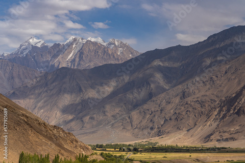 Scenic landscape view of snow-capped Hindu Kush mountain range in Afghanistan near Ishkashim, start of famous Wakhan Corridor, Gorno-Badakshan, Tajikistan Pamir