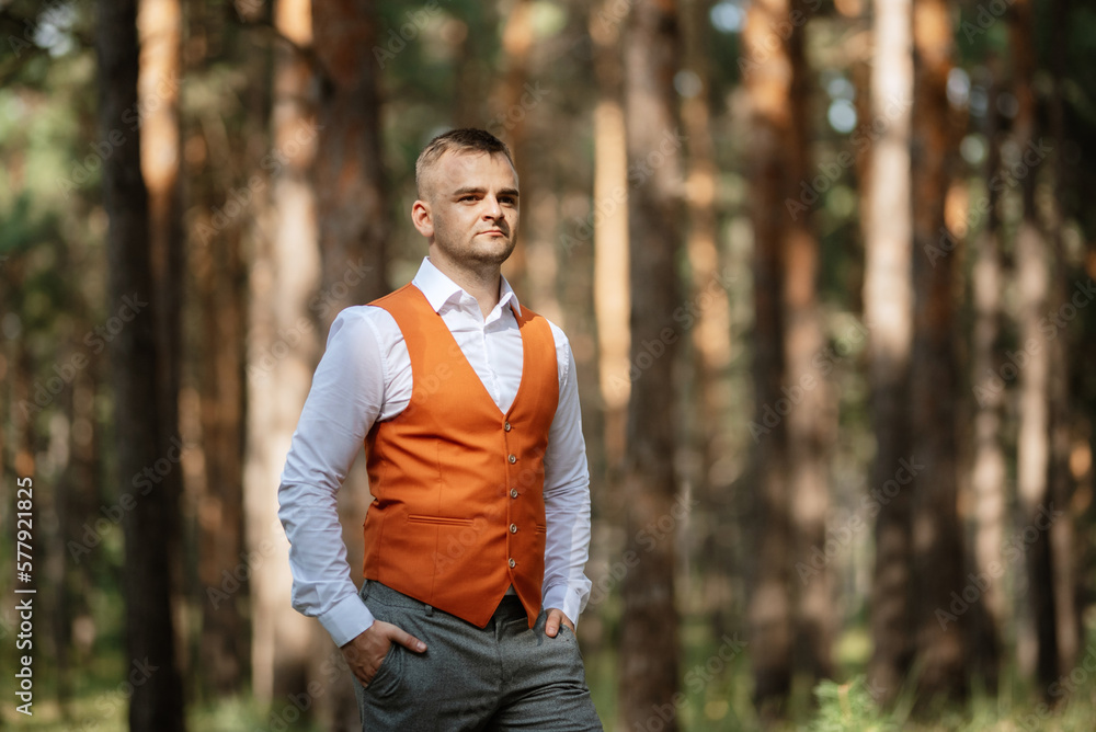 portrait of the groom in a gray suit and an orange vest portrait of the groom in a gray suit and an orange vest