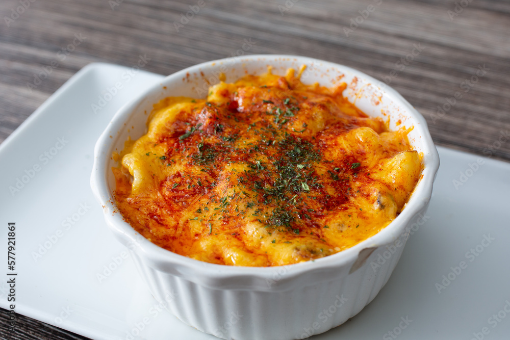 A view of a ramekin bowl of macaroni and cheese dish. A view of a ramekin bowl of macaroni and cheese dish.