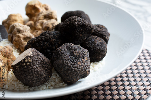 A view of a plate full of black and white truffles.