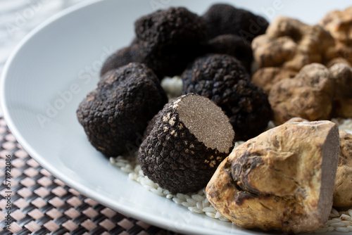 A view of a plate full of black and white truffles.