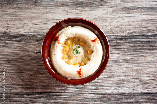 A top down view of a bowl of hummus.