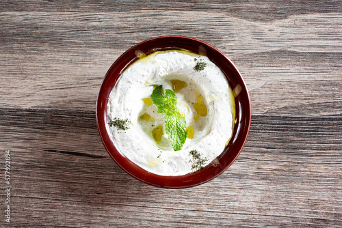 A top down view of a bowl of tzatziki.