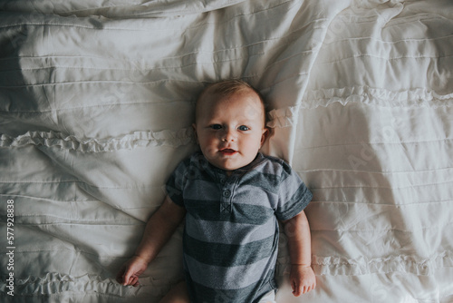 Portrait of baby boy in striped onesie photo