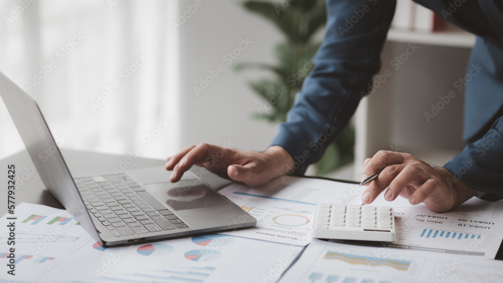 Business men are looking at the company's financial documents to analyze problems and find solutions before bringing the information to a meeting with a partner. Financial concept. Business men are looking at the company's financial documents to analyze problems and find solutions before bringing the information to a meeting with a partner. Financial concept.