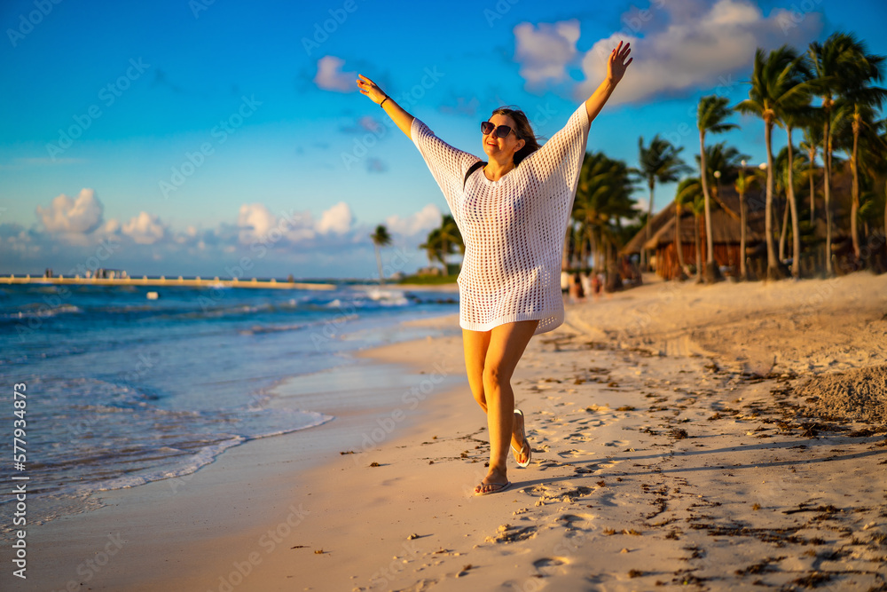 Beach holiday - beautiful woman walking on sunny, tropical beach
Beach holiday - beautiful woman walking on sunny, tropical beach