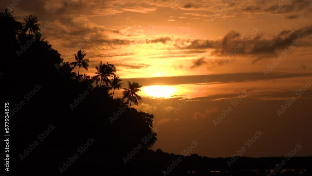 Elevated Shot of a Beautiful Sunset on an Exotic Island and Sea Visible, with Silhouettes of Palm Trees and Buildings Showing. Shot on RED Epic 4K UHD Camera.
Elevated Shot of a Beautiful Sunset on an Exotic Island and Sea Visible, with Silhouettes of Palm Trees and Buildings Showing. Shot on RED Epic 4K UHD Camera.