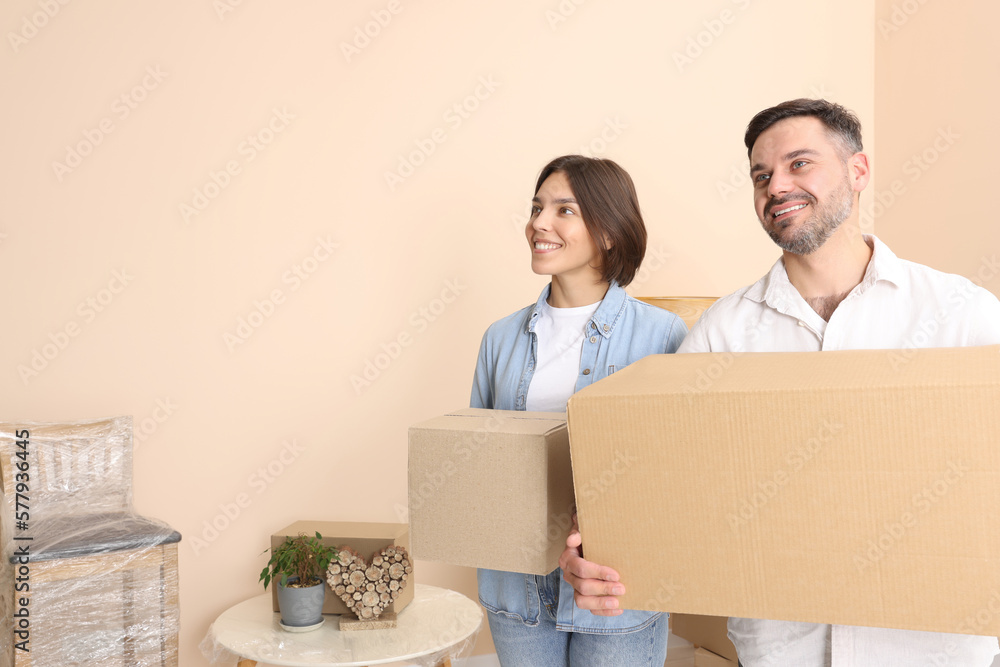 Happy couple with moving boxes in new apartment Happy couple with moving boxes in new apartment
