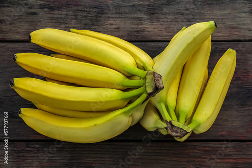 Ripe yellow bananas on wooden table, flat lay